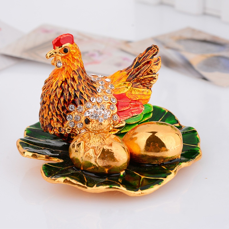 colorful jewelry box depicting the shape of a hen laying eggs